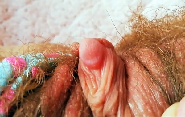 Red hairy pussy with huge clit in close up